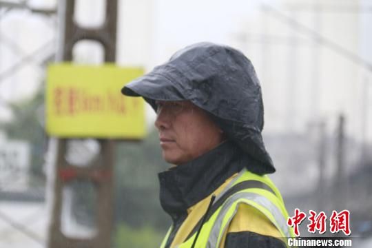 蘭州西工務(wù)段蘭州線路車間防護(hù)員雨中巡查?！⊥豕廨x 攝